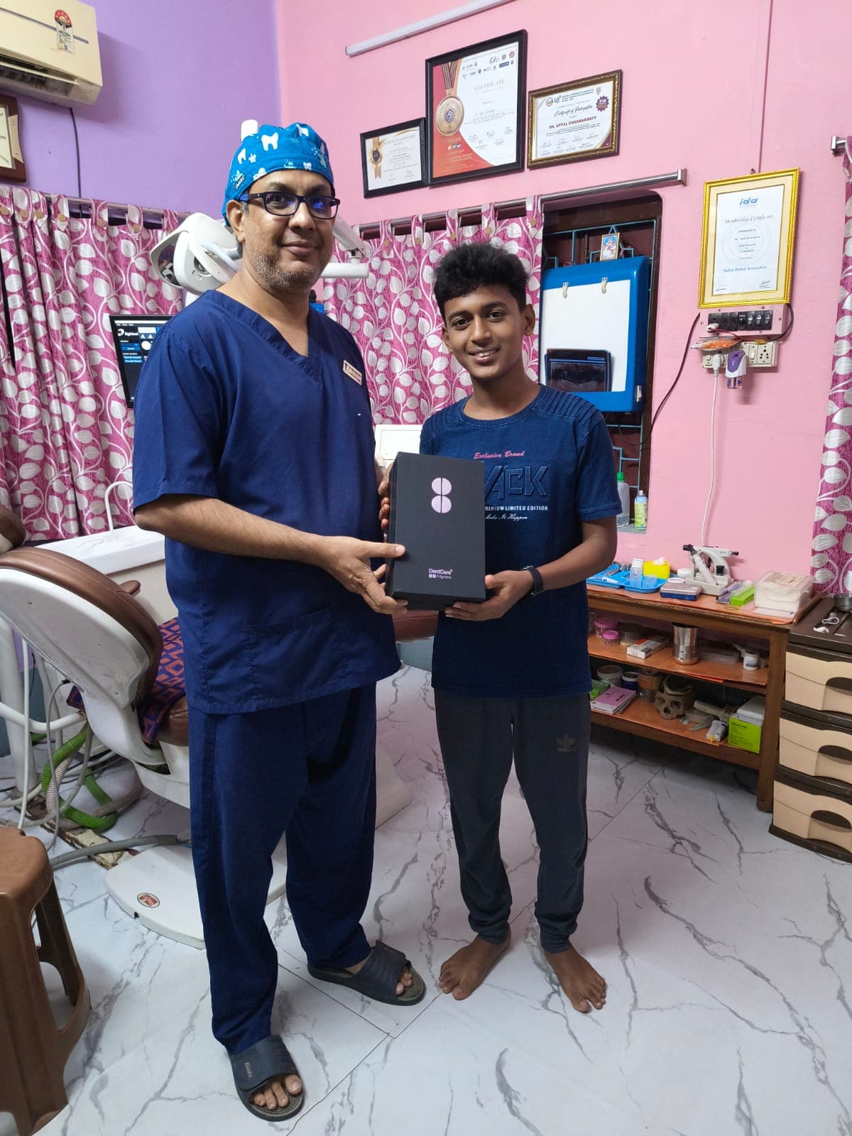 Dr. Utpal Chakraborty giving aligner to Patient